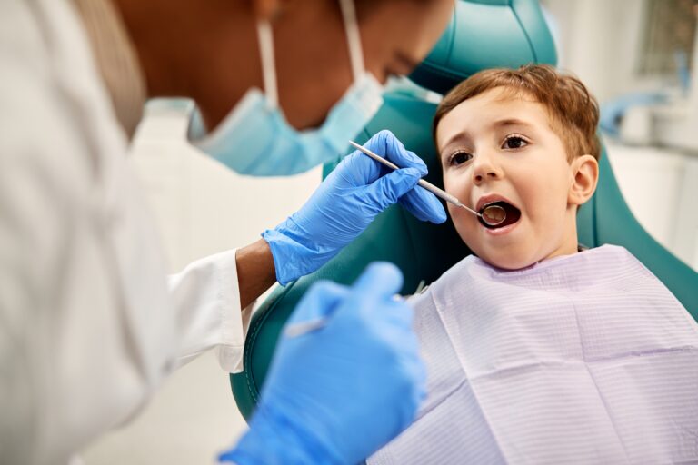 Young child having an urgent dental examination by a dentist, representing dental emergency care